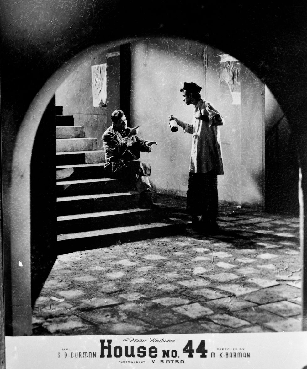 a black and white photo of a man talking to another man