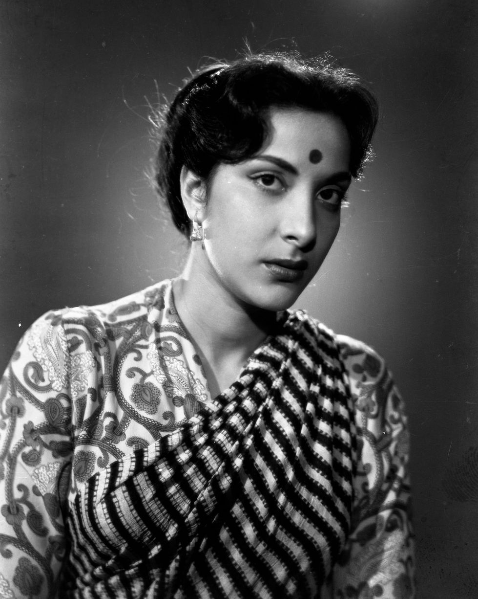 a woman with a bindi on her forehead is wearing a black and white shirt