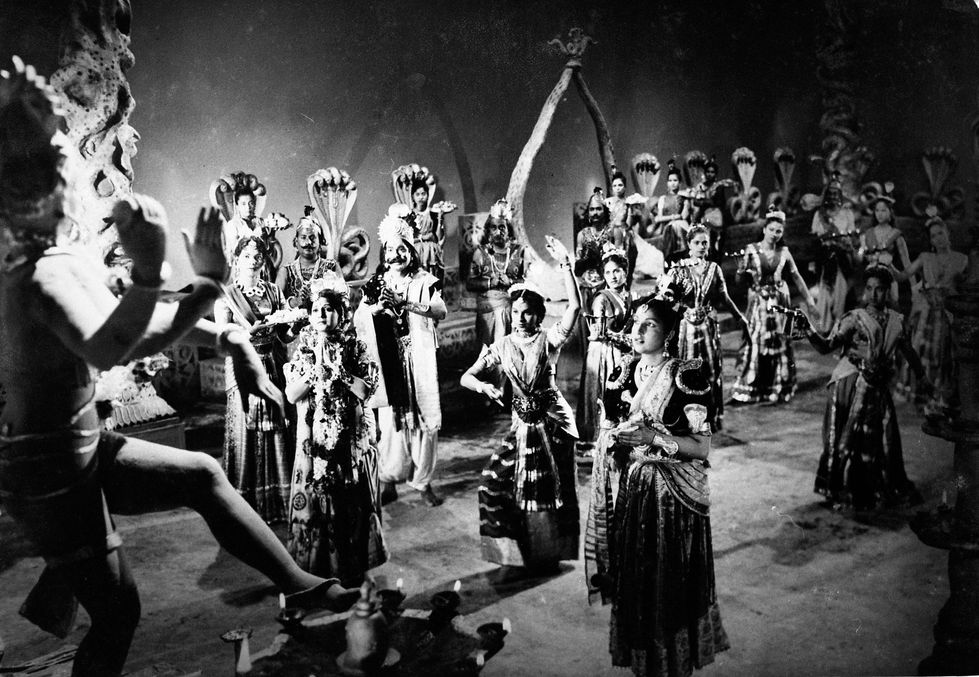 a black and white photo of a group of people dancing