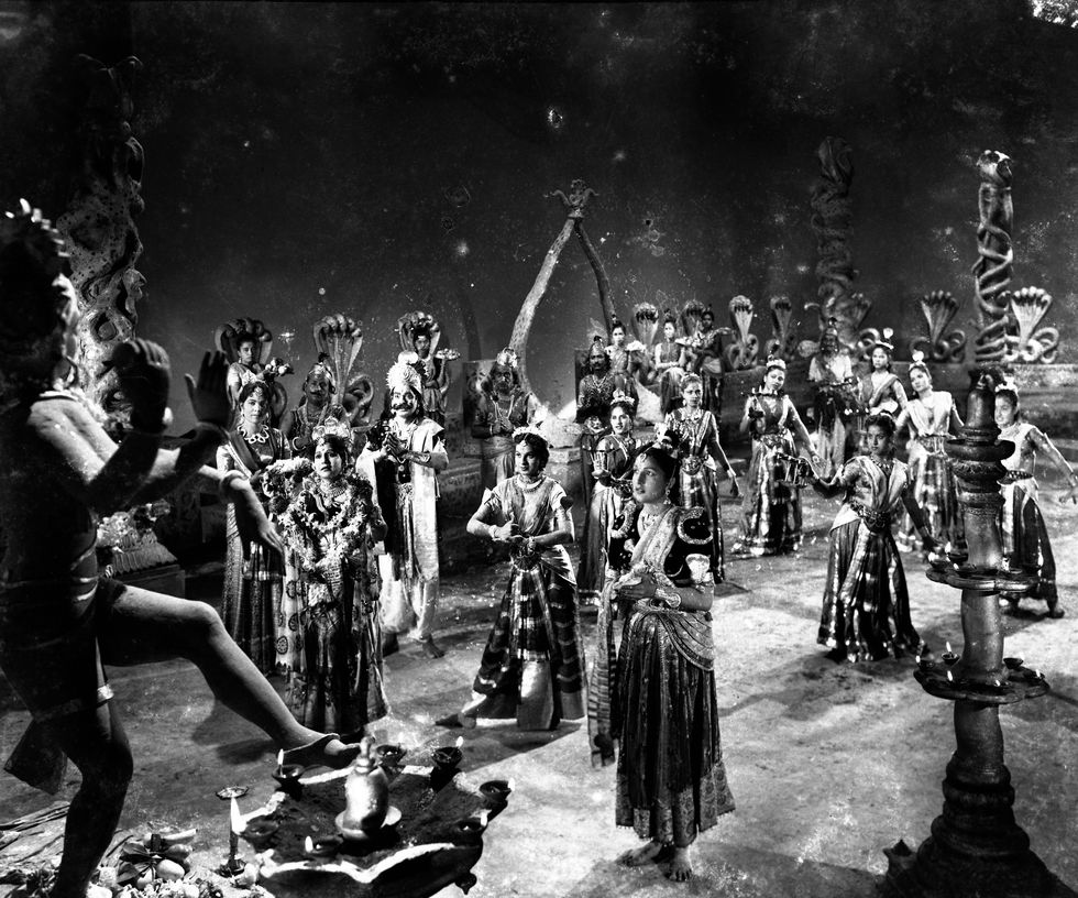 a black and white photo of a group of people dancing