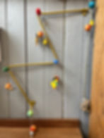Figurines hanging in a wooden wall