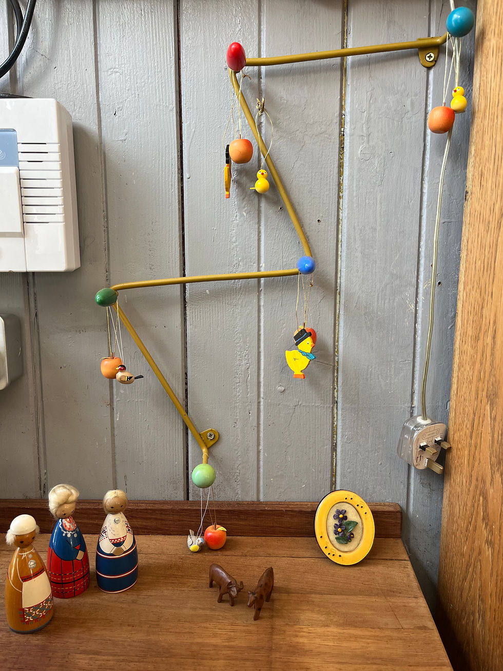 Figurines hanging in a wooden wall