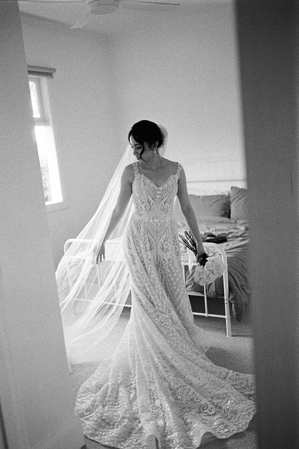 a black and white photo of a woman in a wedding dress