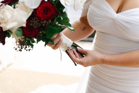 a woman in a white dress holds a bouquet of flowers