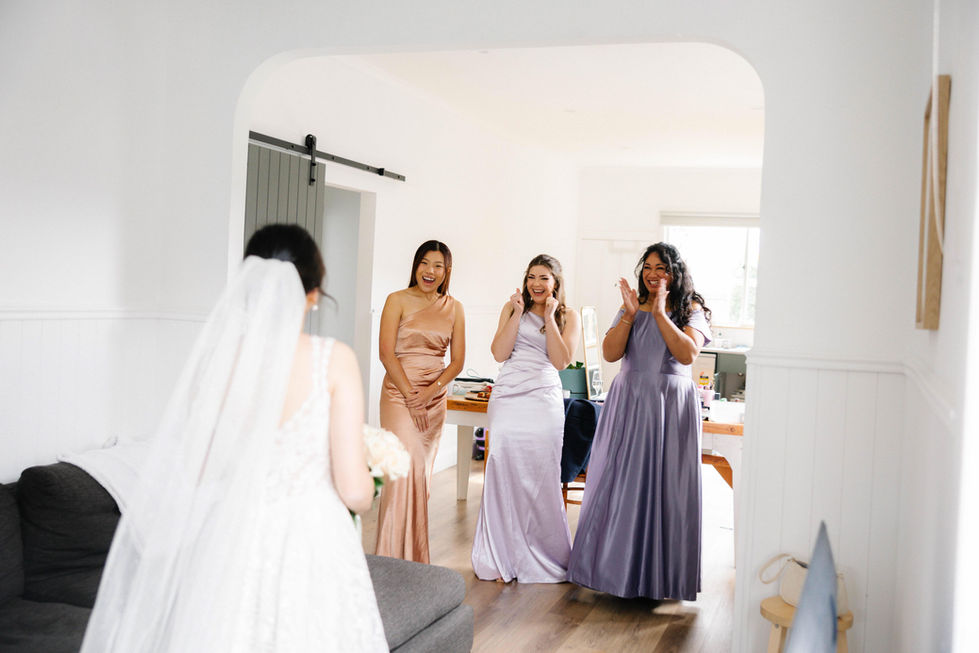 a bride and her bridesmaids are standing in a living room