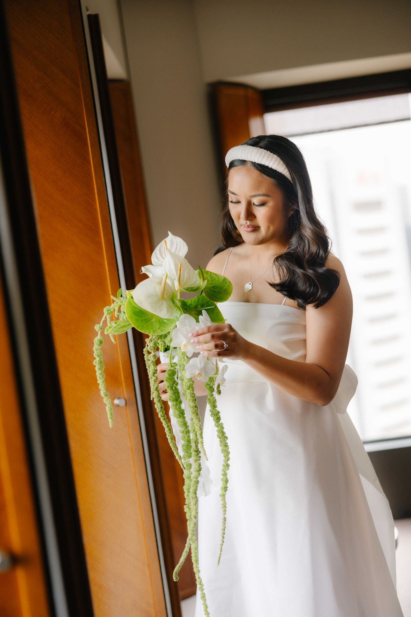 a woman in a white dress is holding a bouquet of flowers