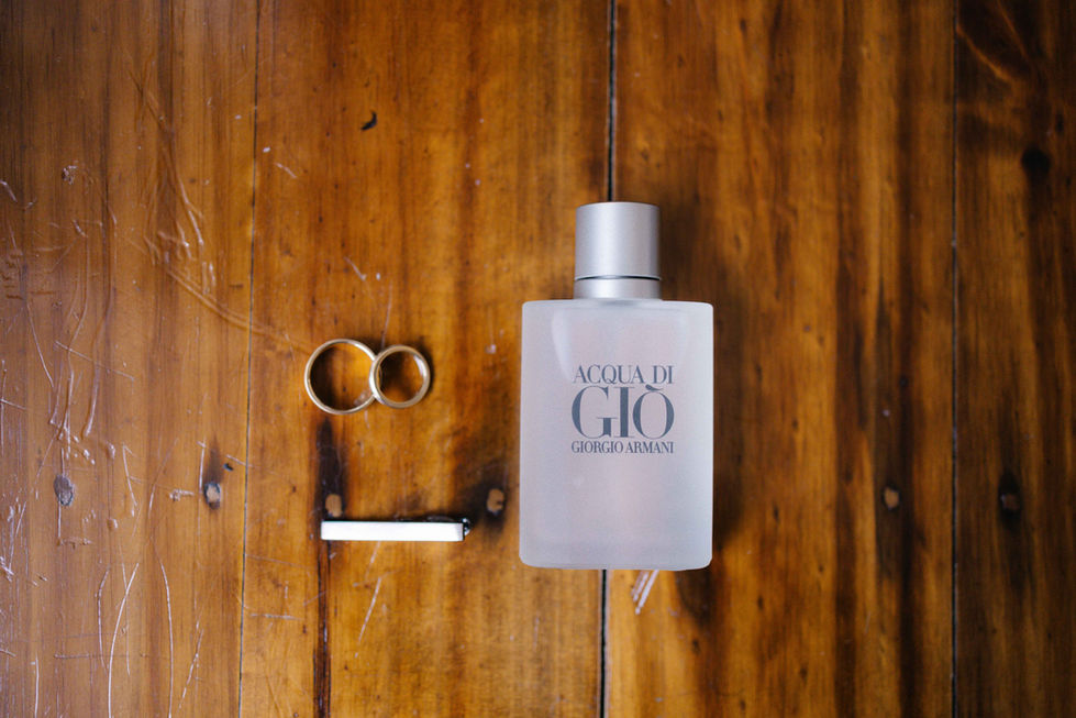 a bottle of acqua di gio sits on a wooden table