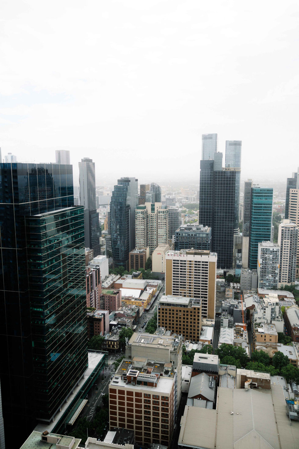 an aerial view of a city with a few buildings including one that says ' sydney ' on it