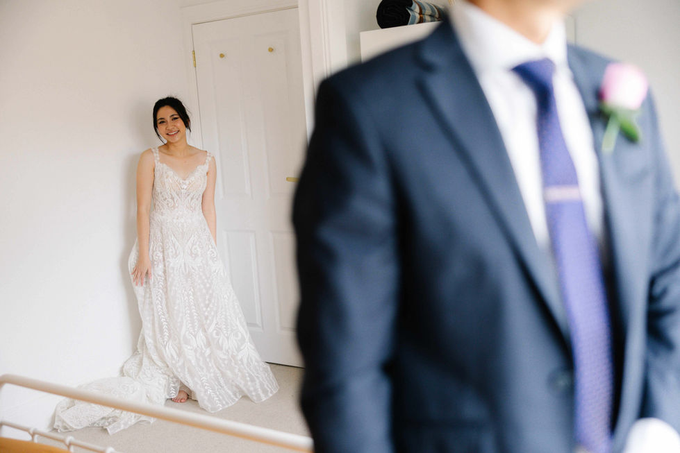 a man in a suit stands next to a woman in a white dress