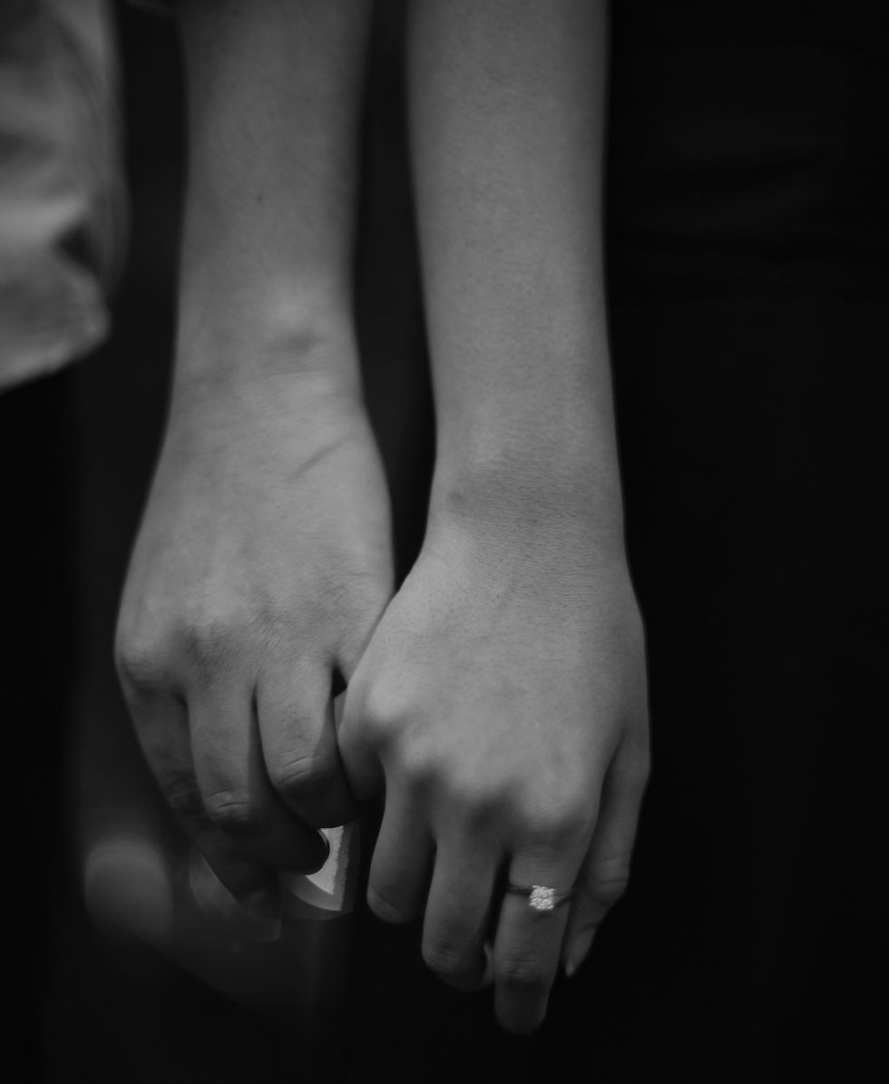 Hands showcasing wedding band rings, a delicate touch between lovers