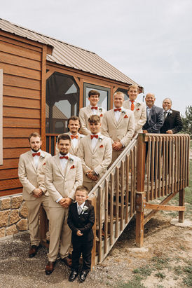 Groomsmen pose for wedding photography, wearing suits and bow ties on outdoor steps. wedding photography Chicago