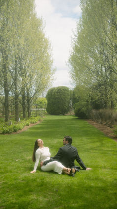Couple sitting on grass, looking into the distance, engagement photography Chicago.
