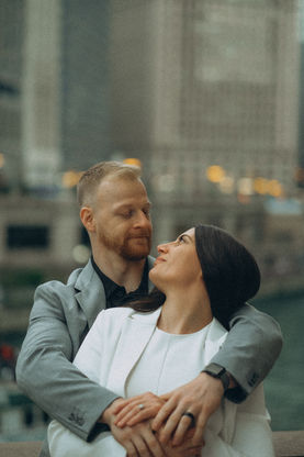 Couple embracing, looking at each other with Chicago skyline background, engagement photography Chicago