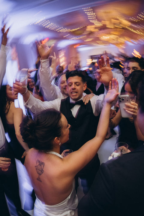 Guests dancing joyfully at a lively reception