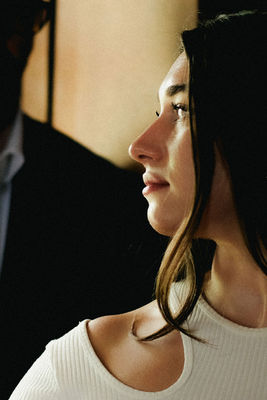 Woman in white shirt, profile and background; engagement photography Chicago.