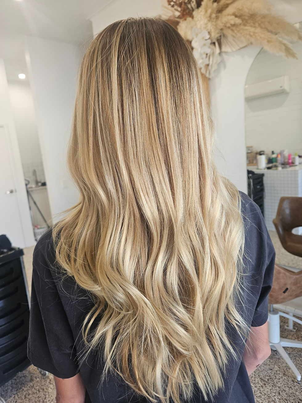 Long blonde premium hair extensions styled at Mila’s House of Hair
