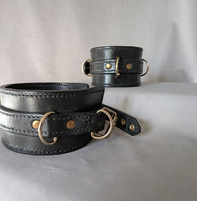 Black leather Control ankle cuffs with decorative eyelets and brass hardware