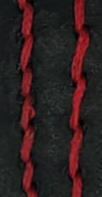 Red thread prominently standing out on black leather.