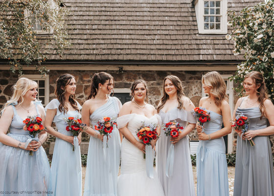 Bridal party red, blue and orange. Free-form bouquets with red anemones, orange ranunculus and blue delphinium