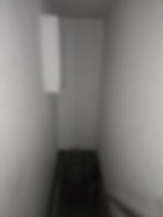 Finished recessed cabinet with drywall and paint above the stairwell