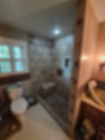 Completed walk-in tile shower with bench and custom niches in Indian Hills, Louisville KY