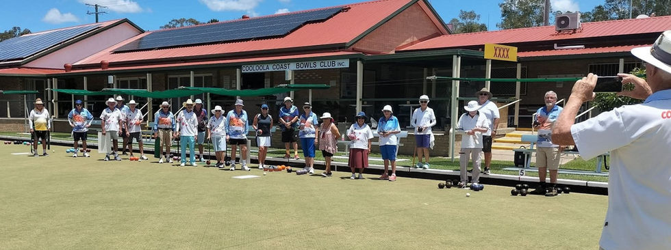lawn bowlers on green in front of clubhouse