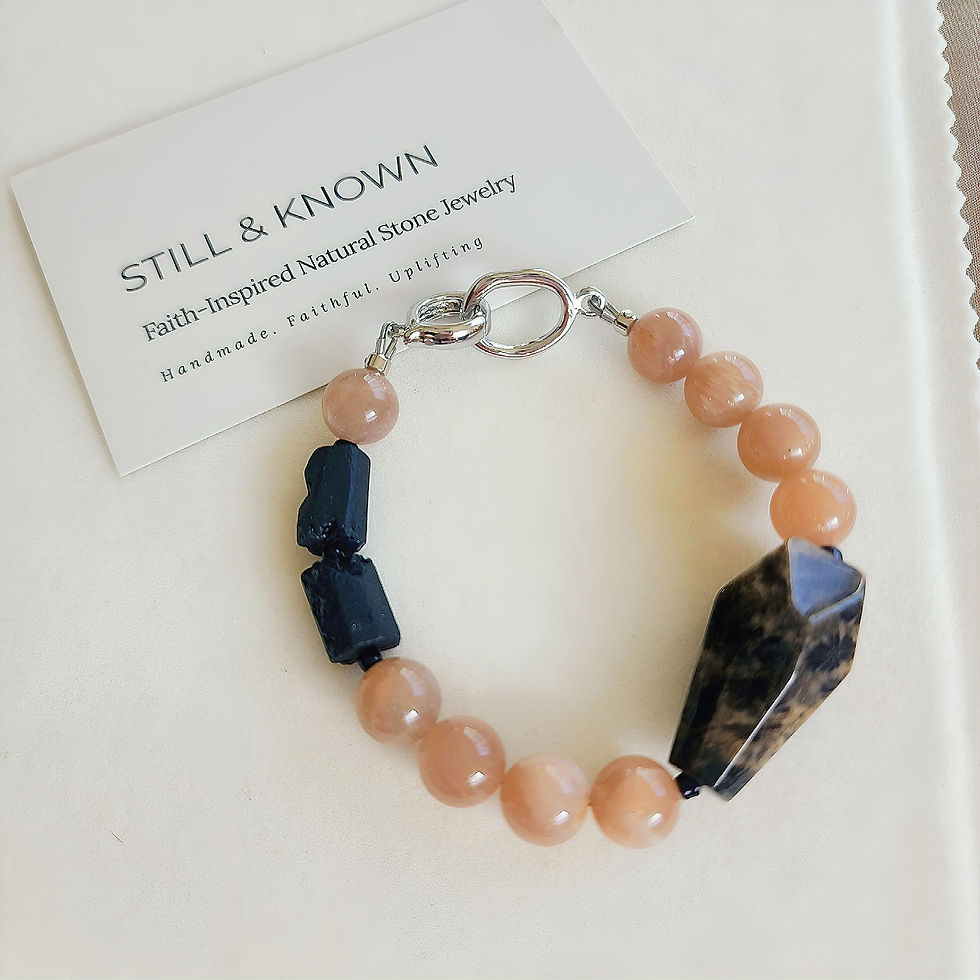 Thumbnail: Faith-inspired pink gemstone bracelet with silver clasp, black tourmaline, and unique patterned centerpiece stone.