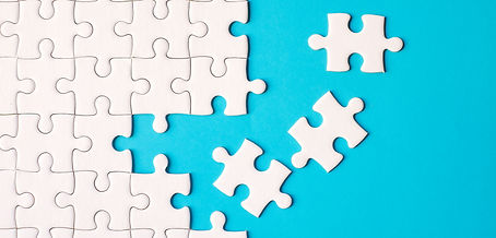 Many white jigsaw puzzle on blue background - idea solution concept..jpg