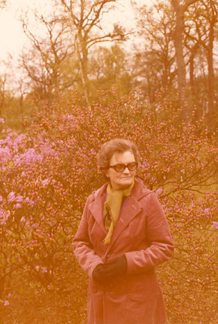 A photograph of a woman walking in woodland is compromised by a pronounced red colour cast.