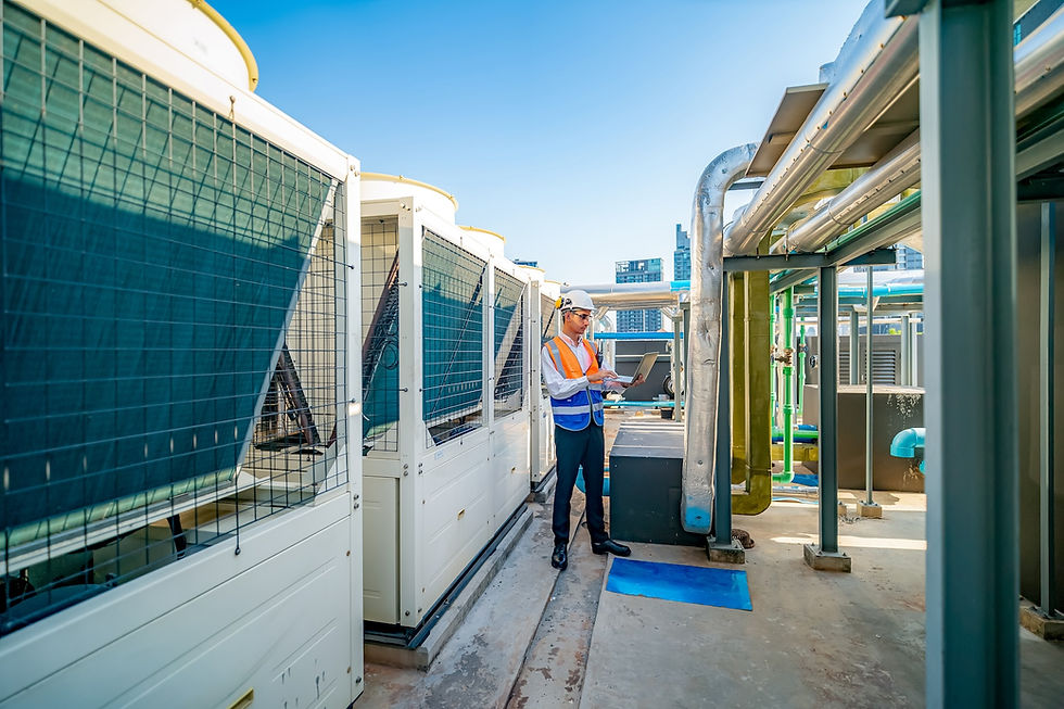 Maintenance worker on the roof of a building inspecting and calibrating the HVAC system
