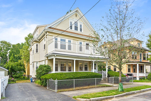 yellow house with front porch and second floor porch