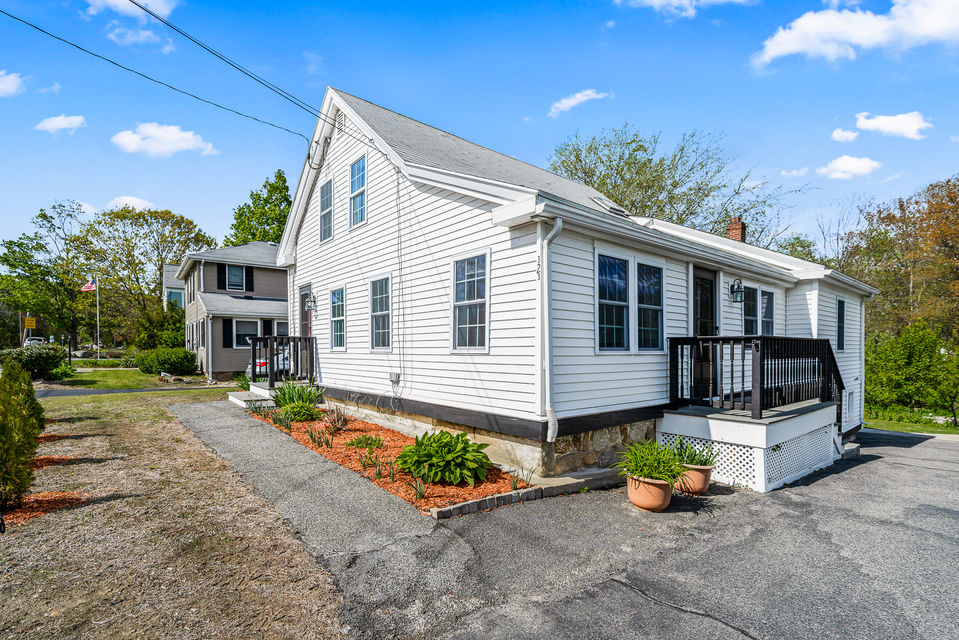 white house with lots of parking