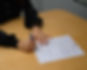 Close-up of a person signing the Leading Edge Real Estate Pledge, a commitment to delivering exceptional client service, maintaining high ethical standards, and fostering a collaborative and supportive real estate community.