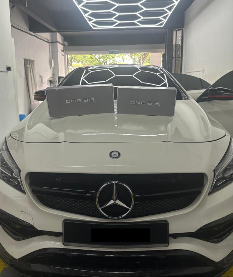 premium car speakers displayed in front of Mercedes for audio upgrade showcase