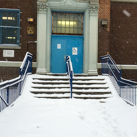 School main entrance steps covered with snow.