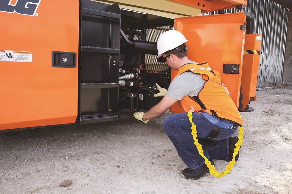 Worker inspecting engine during scissor lift hire maintenance
