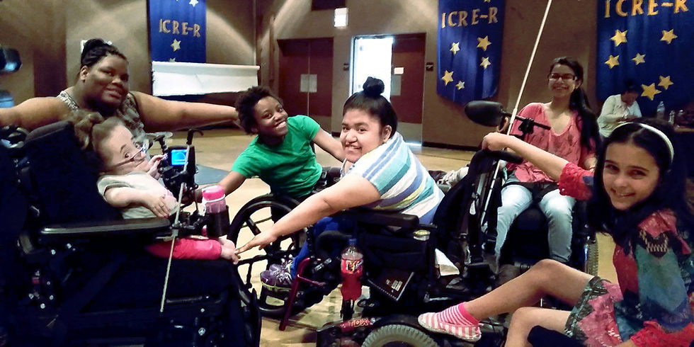 A diverse group of teenaged wheelchair users dancing together and smiling brightly.