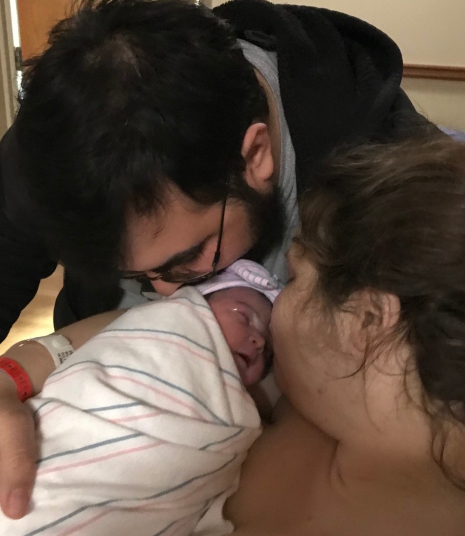 Mom and Dad admire their new baby