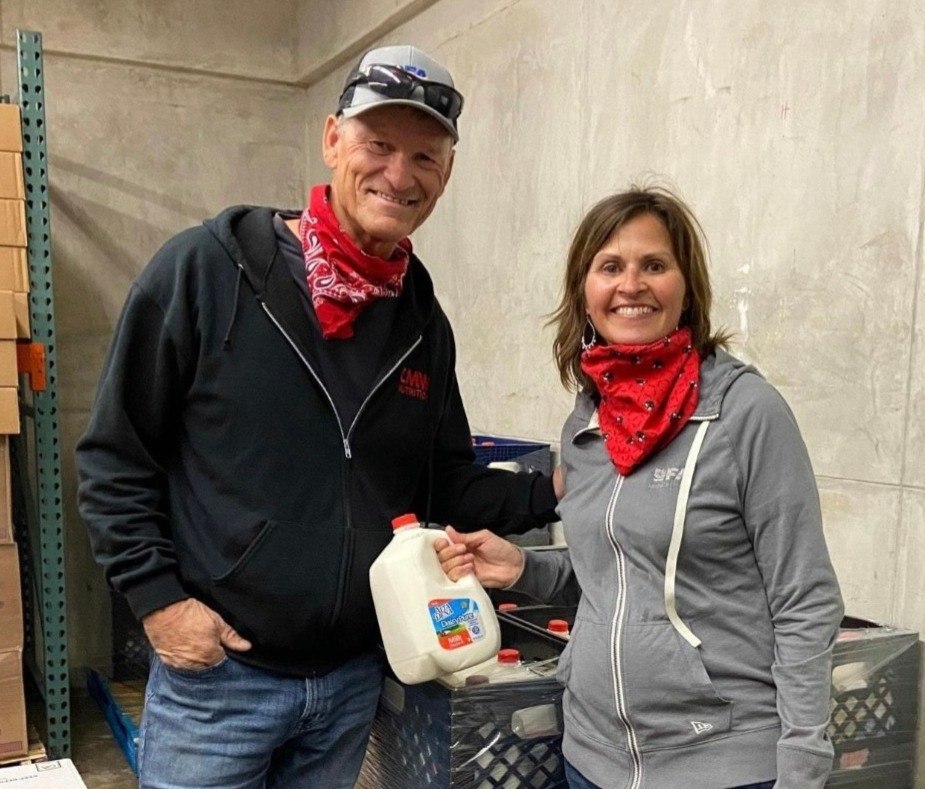 Dairy farmers, Ken and Sherrie DeVries of Hinkley Dairy deliver donated milk to local food bank.