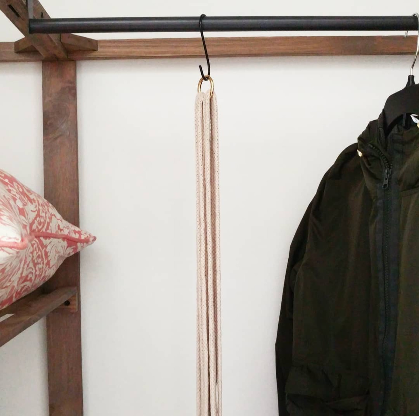 Macramé project hanging from a closet rod