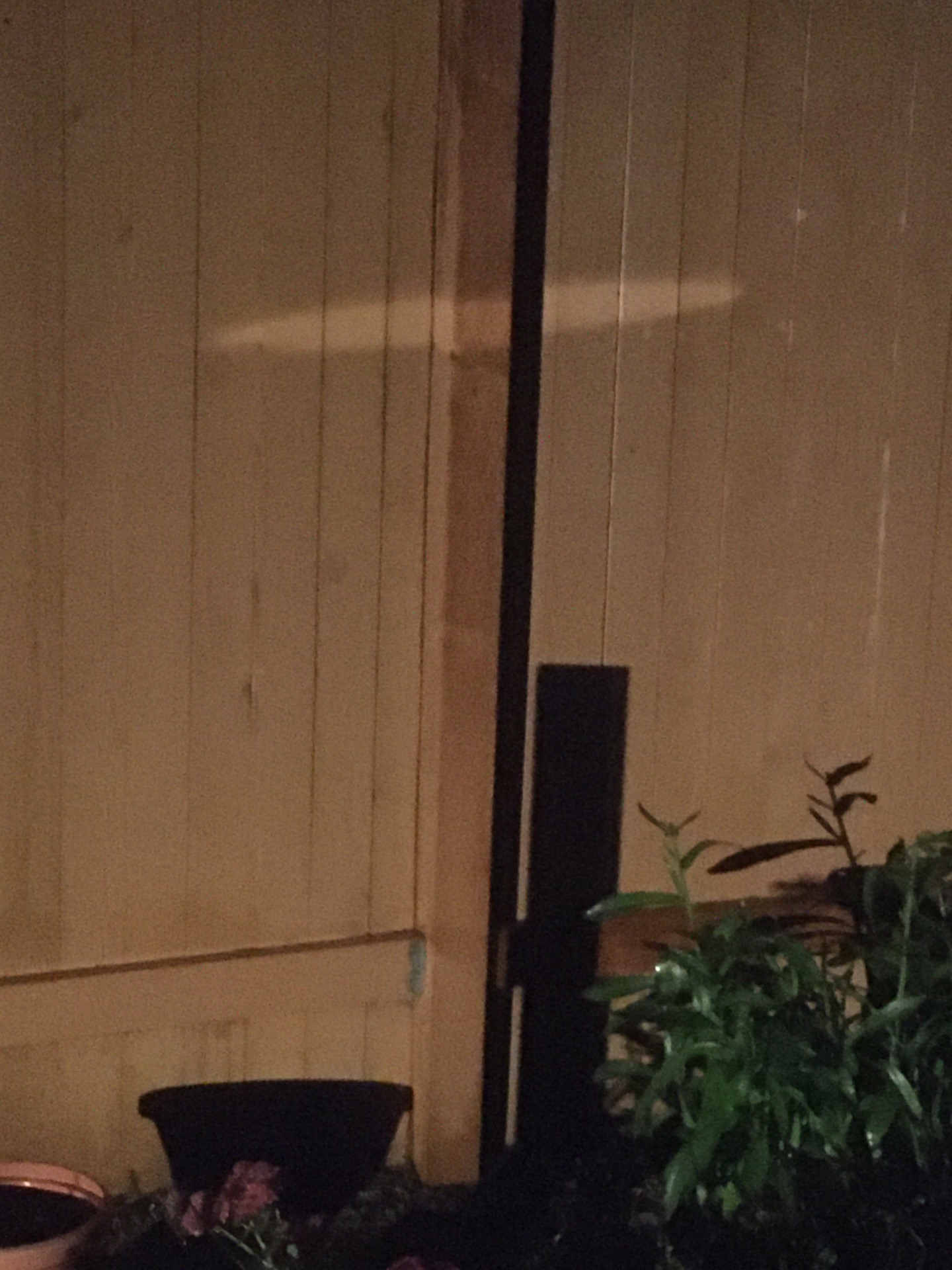 A random light reflection creating this Cross on the fence. content media