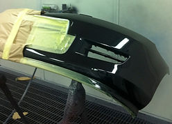 spraying car part in a spray booth that is protected by protectapeel spray booth protection coating