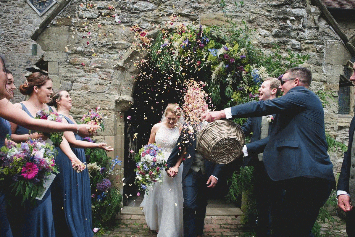 Gif of lots of confetti being thrown at a wedding
