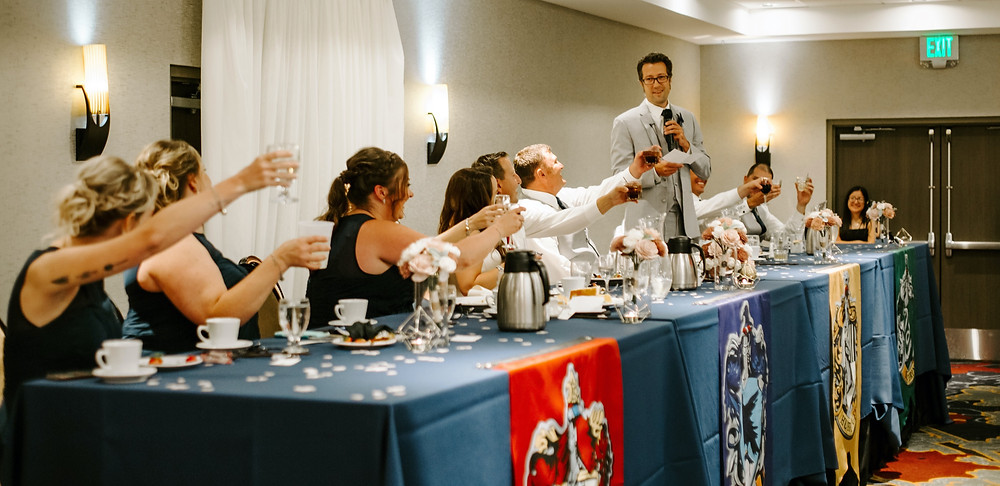 Traditional Head Table with Harry Potter house flags, bride, groom, and wedding party