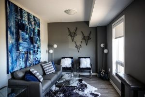 A small living room with a statement rug and wall décor