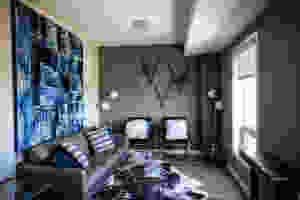 A small living room with a statement rug and wall décor