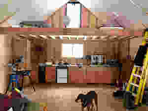An unfinished kitchen under a loft in a diy cabin