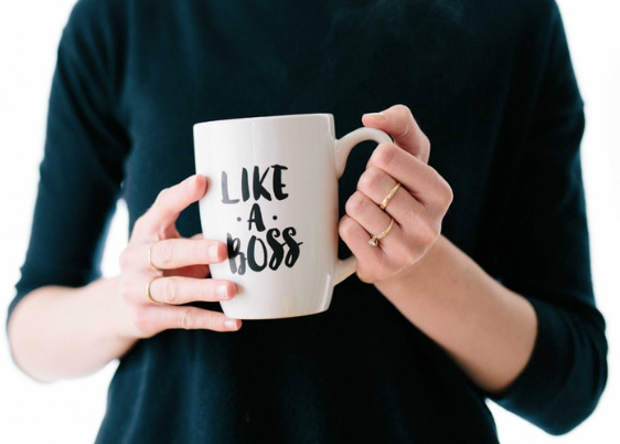 woman holding a cup which says Like a Boss