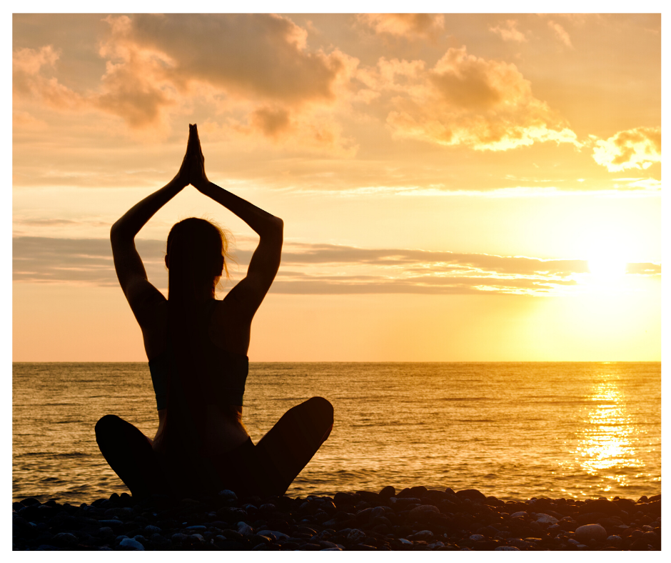 A woman with healthy shoulders in a yoga pose on the beach