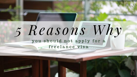 a desktop with a laptop, a tablet and a mug, books and papers. Freelancer workspace